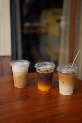 many cup of ice coffee on the wood table