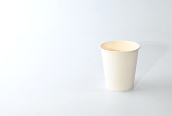 White paper disposable glass for water or coffee or tea on a white background