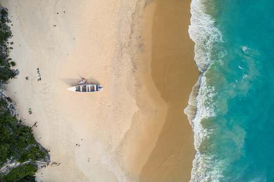Ariel drone view of a seashore or beach area with boat, Nice bluish color and mesmerizing scene of ocean and nature