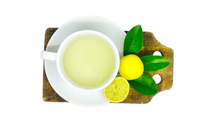 A cup of lemon wedang or lemon tea in a cup and saucer served with lemon slices on a white background. A cup of hot lemon juice for health.