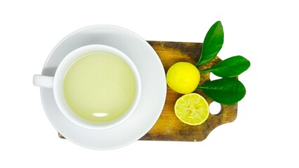 A cup of lemon wedang or lemon tea in a cup and saucer served with lemon slices on a white background. A cup of hot lemon juice for health.