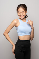 Young beautiful smiling asian woman with sportswear on isolated white background. Portrait happy healthy slim fit and firm attractive sporty woman standing pose exercise workout in studio.