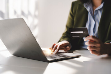 Portrait of entering credit card information on a laptop. Shopping online credit card login