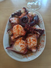 Tipical Spanish food: octopus y traditional Galician style, cooked with boiled potatoes, olive oil, spicy paprika and coarse salt.