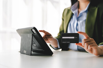 Portrait of person entering credit card information on tablet, shopping online Online credit card payment concept