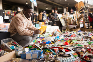 Man chooses antiques at a flea market