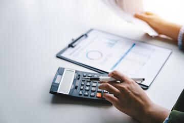 Portrait of a young woman calculating the bill for expenses to be paid. Financial concepts, debt repayment and bank finance.