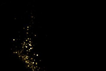 Golden blurred bokeh lights on black background