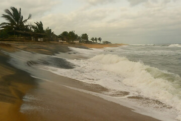 Abandoned hotel in storm on the ocean coast in Liberia