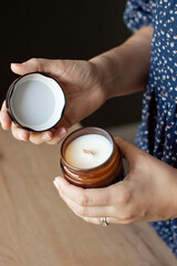 Woman Holding Aromatic Candle with Care