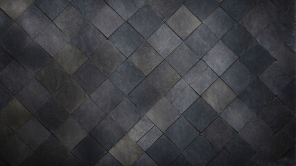 A selection of grey diamond-shaped tiles forming a modern and sophisticated textured decorative wall pattern.