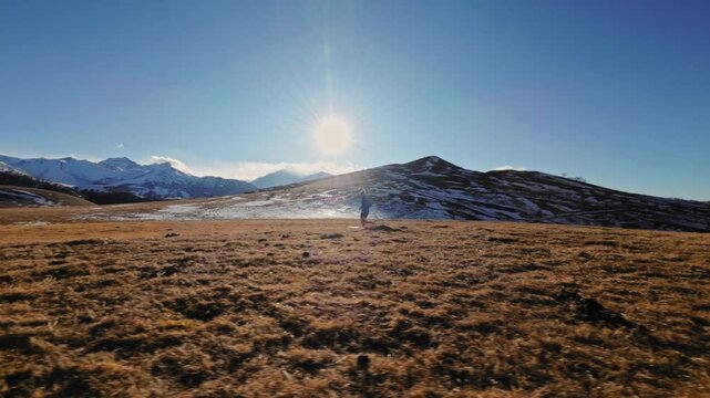 Aerial view man running, freedom, energy, mountain hike trail, FPV drone, happy guy runs trekking route hills valley summit, outdoor in nature, burst of energy