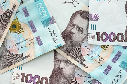 Big amount of ukrainian new one hundred hryvnia money bills with modern design. Financial concept, business