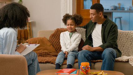 African American family together psychologist doctor writing man father dad tell parenting...