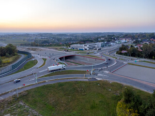 Large traffic circle, street, aerial view. Sunset in the city.