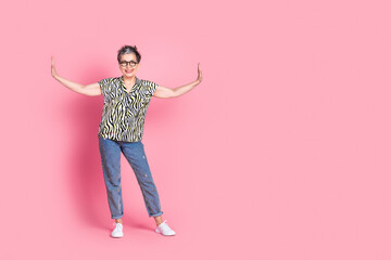 Full body portrait of pretty aged lady arms push empty space wear zebra print shirt isolated on pink color background