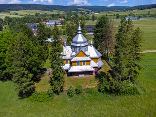 Aerial View of a Traditional Wooden Orthodox Church in a Rural Landscape