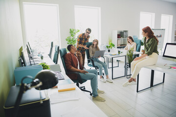 Photo of happy smiling students enjoying business school studying modern device indoors workplace workstation