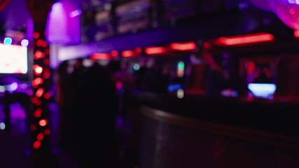 Experience a vibrant nightlife scene filled with dazzling neon lights at a stylish modern bar atmosphere