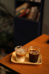 two cups of ice coffee on the wood table