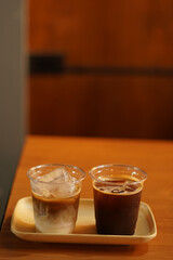 two cups of ice coffee on the wood table