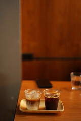 two cups of ice coffee on the wood table
