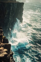 Majestic cliff with crashing waves below under sunny sky