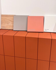 Modern Color and Material Palette Display with Terracotta, Gray, and Wooden Samples