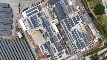 Aerial view of industrial facility with extensive solar panel installation and surrounding areas...