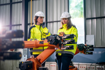 Engineers Collaborating on Robotics Project in Industrial Facility During Daylight © FotoArtist
