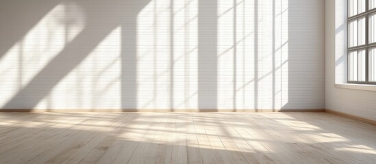 Spacious white loft interior with natural light shadows on walls and warm wooden flooring enhancing modern home aesthetics