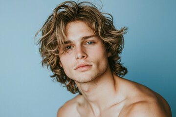 Young Man with Long Wavy Blond Hair Posing