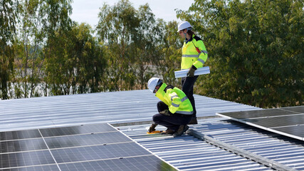 Workers Install Solar Panels on a Rooftop in a Green Energy Project