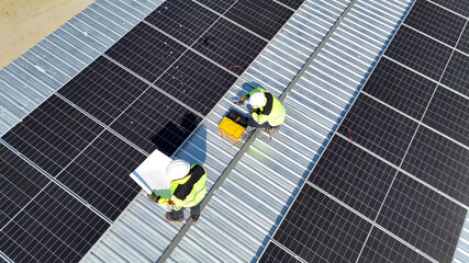 Workers Installing Solar Panels on a Rooftop in a Sunny Location During Daylight Hours