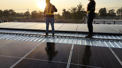 Workers Install Solar Panels on a Rooftop During Sunset for Renewable Energy Project