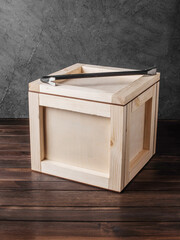 wooden box with crowbar on dark background