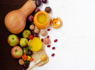 Seasonal autumn fruits with honey of the new harvest on the table.