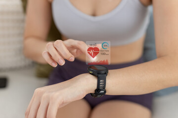 Women Point to smartwatch displaying heart rate application. Monitoring virtual display measure heart rate before after physical exercise. wristwatch checking heart beats and pulse.