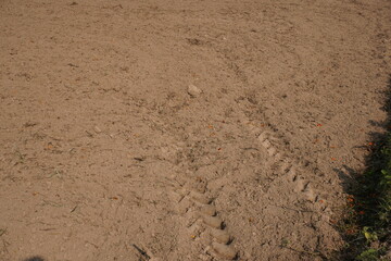 Agriculture field with tractor tyres impression