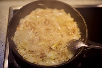 a pan of fried onions on a stove