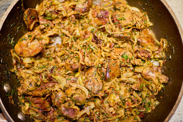 a pan with chicken liver, onion, garlic and dill