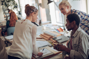 Young people working on a project together in a startup company office