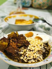 A bowl of Rawon, a rich and flavorful Indonesian beef stew.