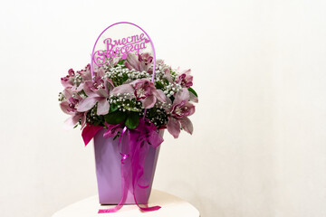 Festive wedding bouquet of pink lilac orchids and white gypsophila. Beautiful flowers on the white background. 