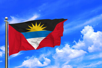 Antigua and Barbuda National Flag Waving Against a Bright Blue Sky
