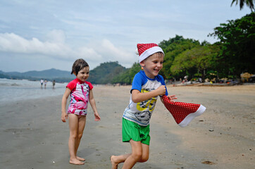 kids in Santa hat on the beach