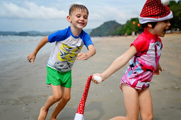 kids in Santa hat on the beach