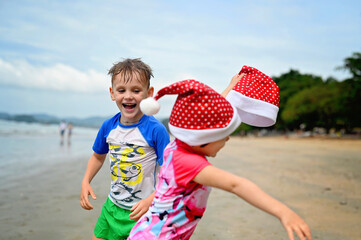 kids in Santa hat on the beach