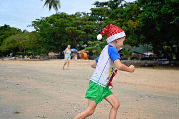 kids in Santa hat on the beach