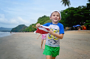 kids in Santa hat on the beach